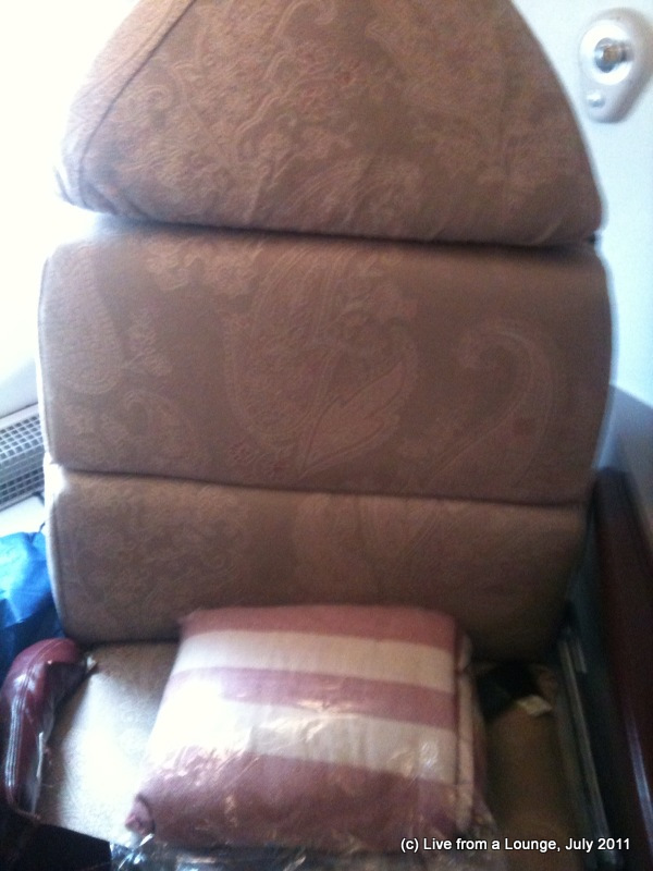 a stack of chairs with pillows