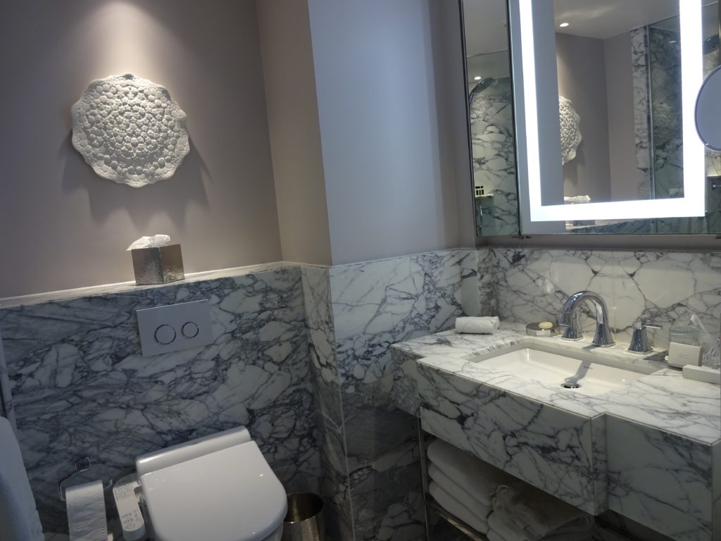 a bathroom with marble countertop and sink