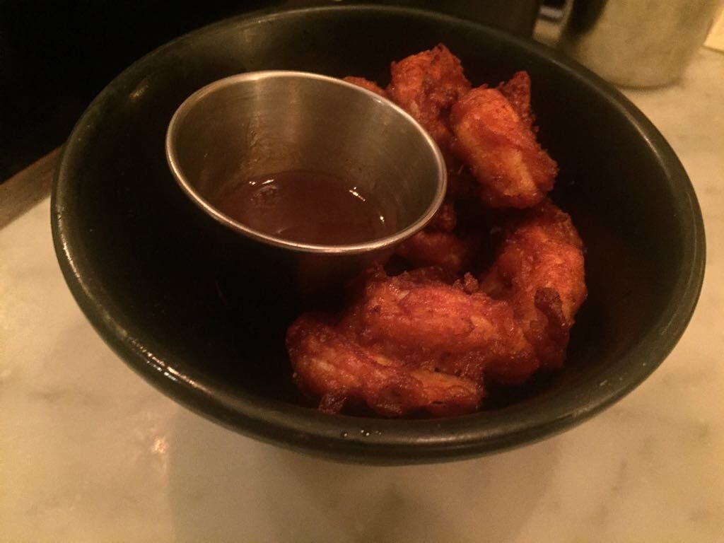 a bowl of fried chicken with sauce