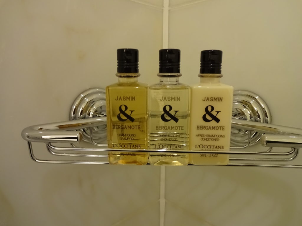 a group of bottles of shampoo on a rack