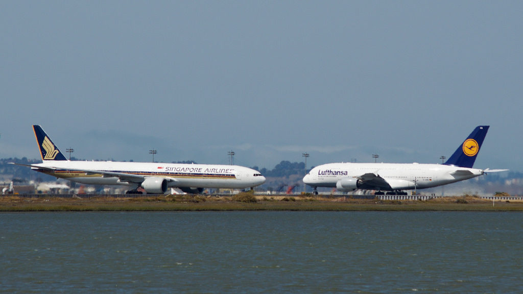 a group of airplanes parked on the runway