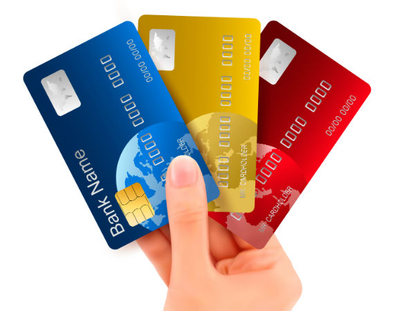 a hand holding credit cards