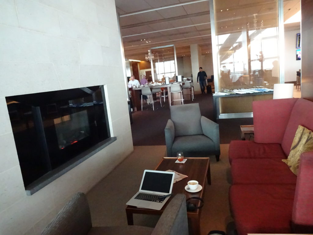 a room with a fireplace and a laptop