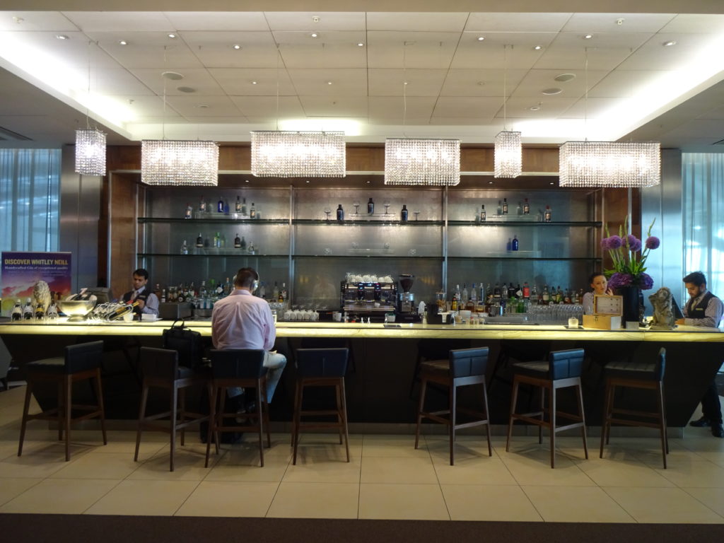 a bar with a counter and a group of people sitting at it