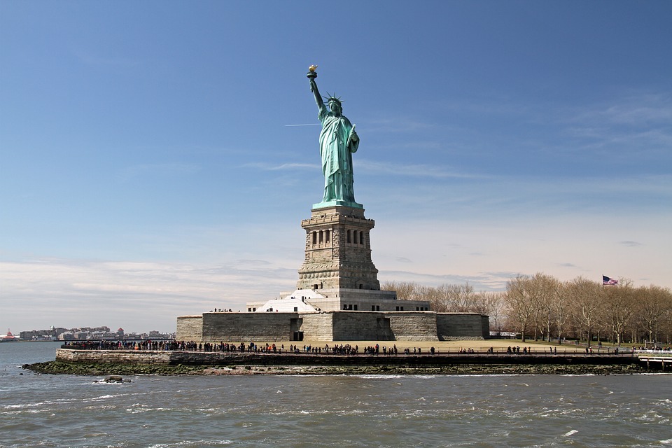 a statue of liberty with people around it