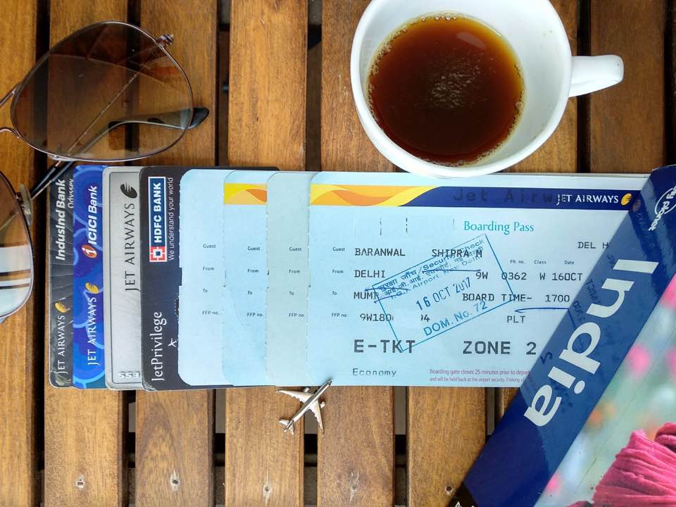 a coffee cup and tickets on a table