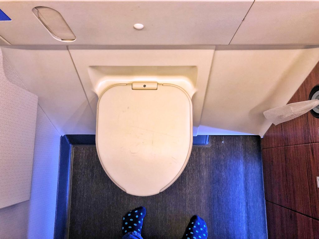 a person's feet in a toilet