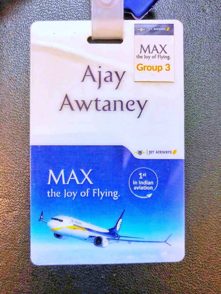 a white and blue tag with a picture of an airplane
