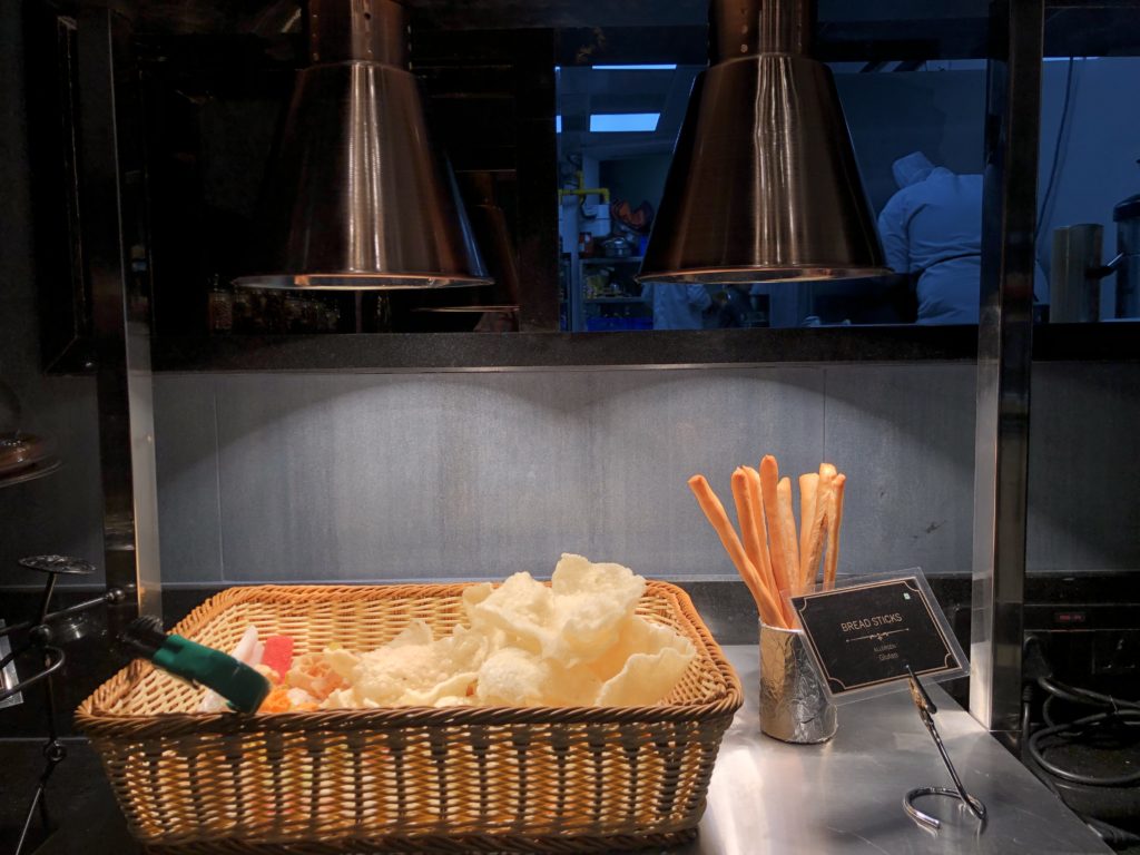 a basket of chips and bread sticks on a counter