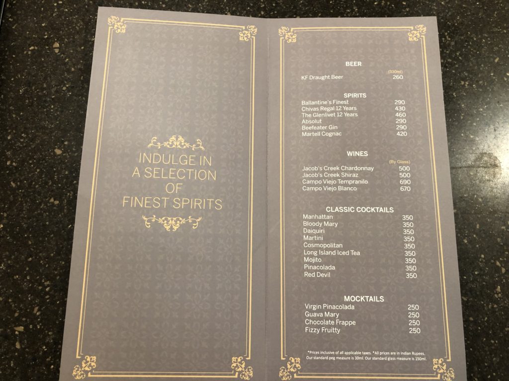 a menu with gold text and price list