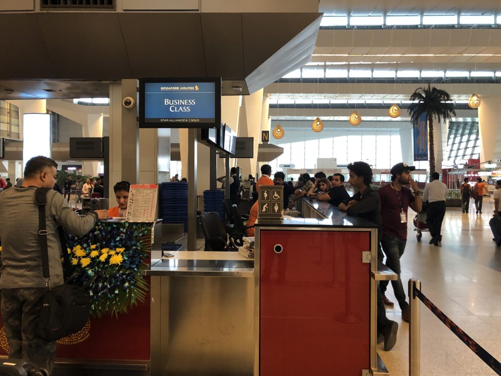 people at a check-in counter in a airport