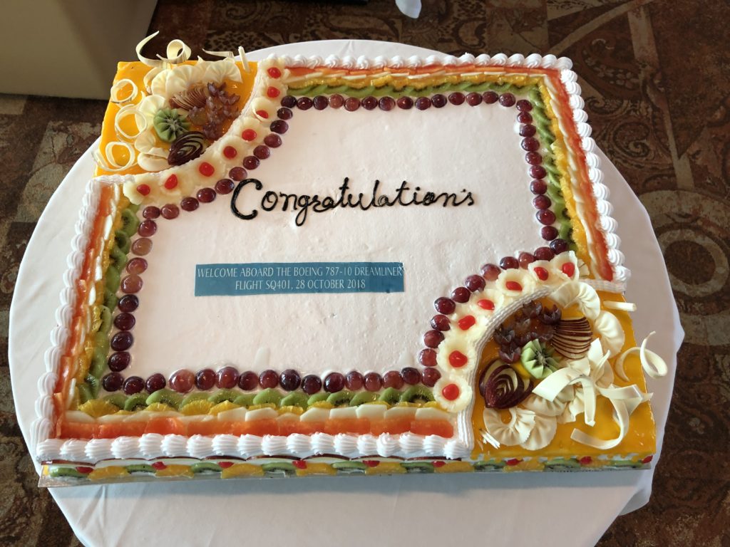 a cake with a white frosting and fruit decorations