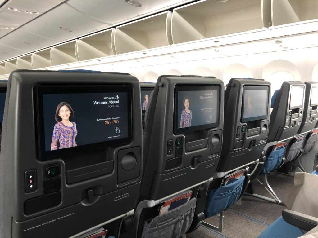 a row of seats with a screen on the back