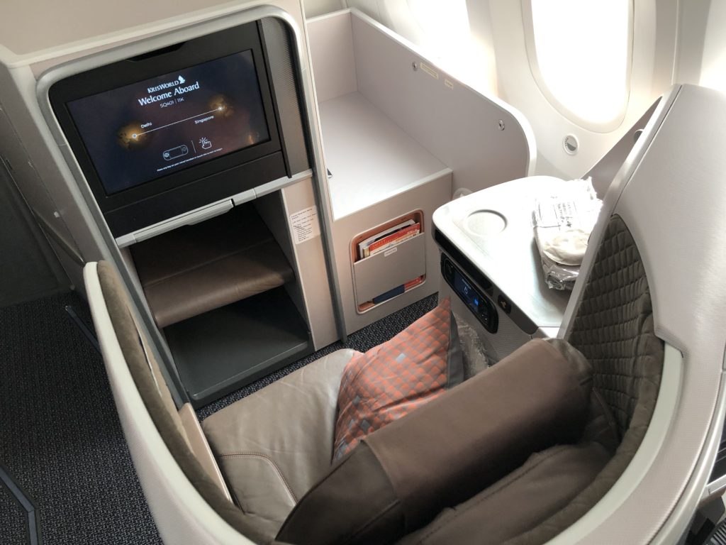 a tv and a chair in an airplane