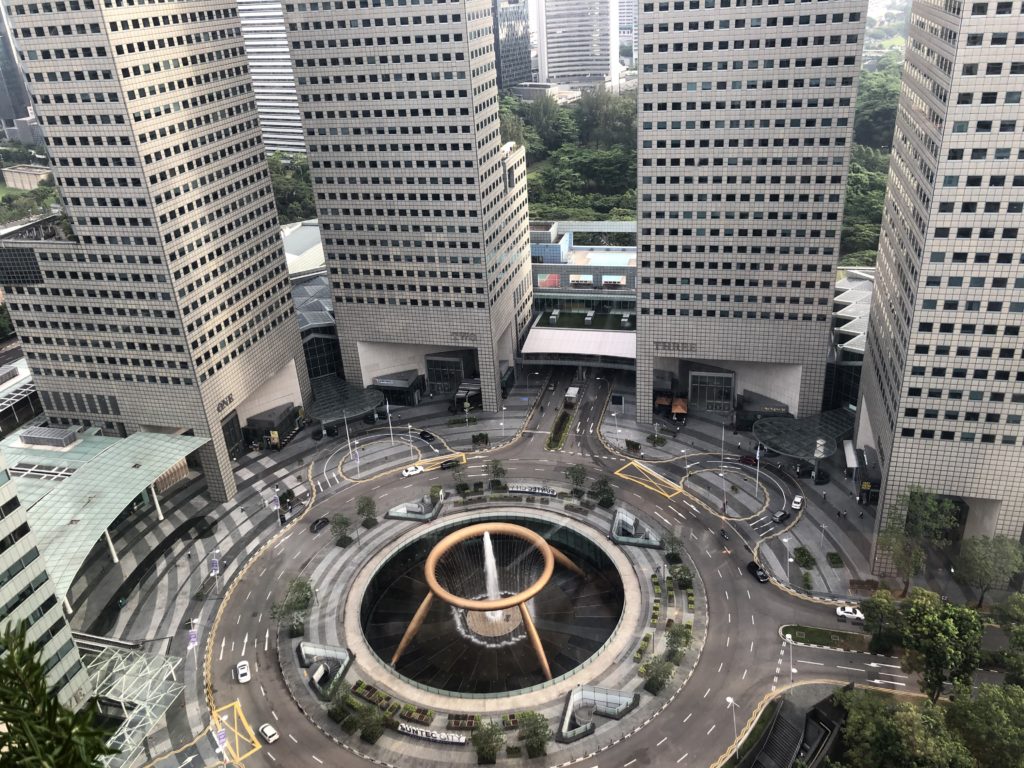 a circular fountain in a city