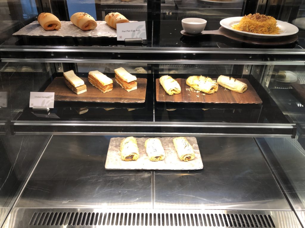 a display case with pastries and food on it