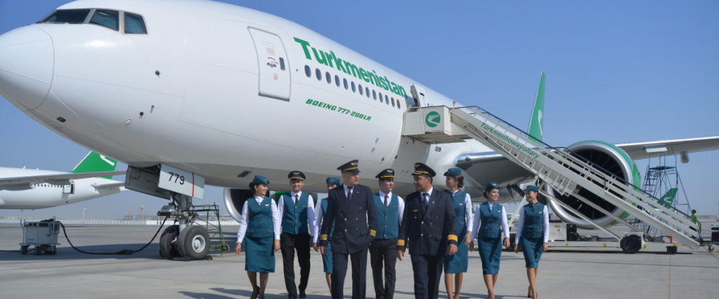 a group of people in uniform standing in front of an airplane