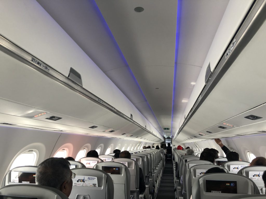 inside an airplane with people in the seats