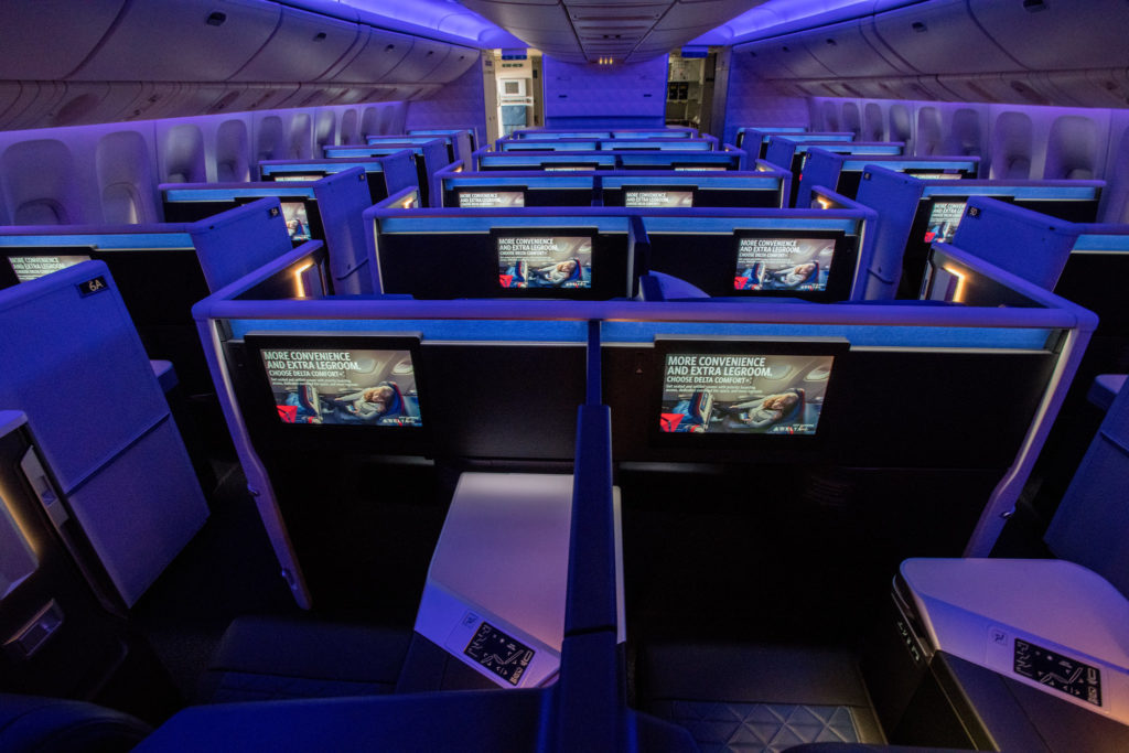 a row of rows of computer screens in an airplane