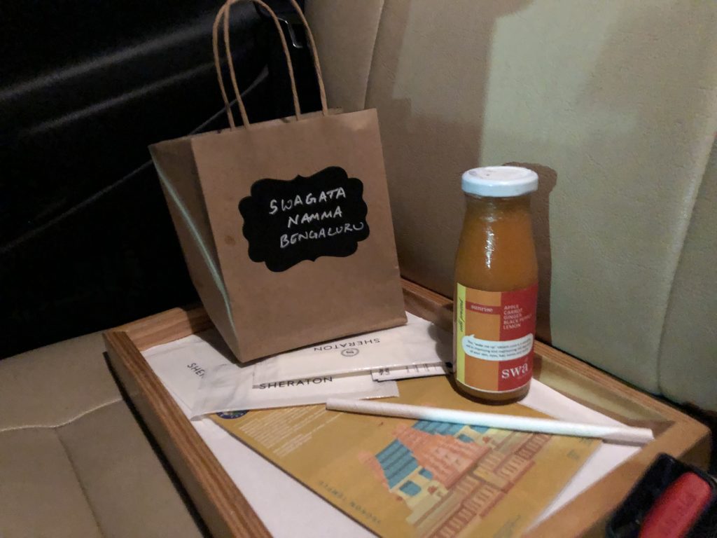 a brown bag and a bottle of juice on a tray