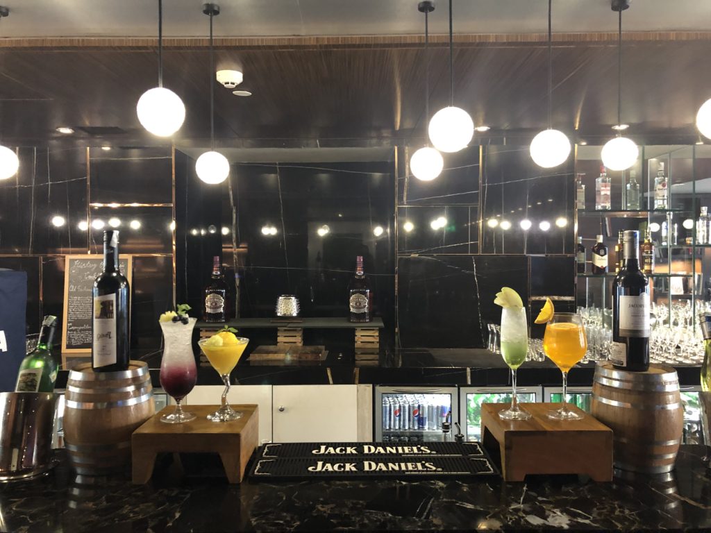 a bar with a variety of drinks