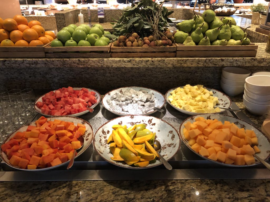 a group of plates of fruit on a counter