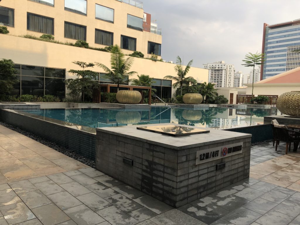 a pool with a fountain in the middle of a building