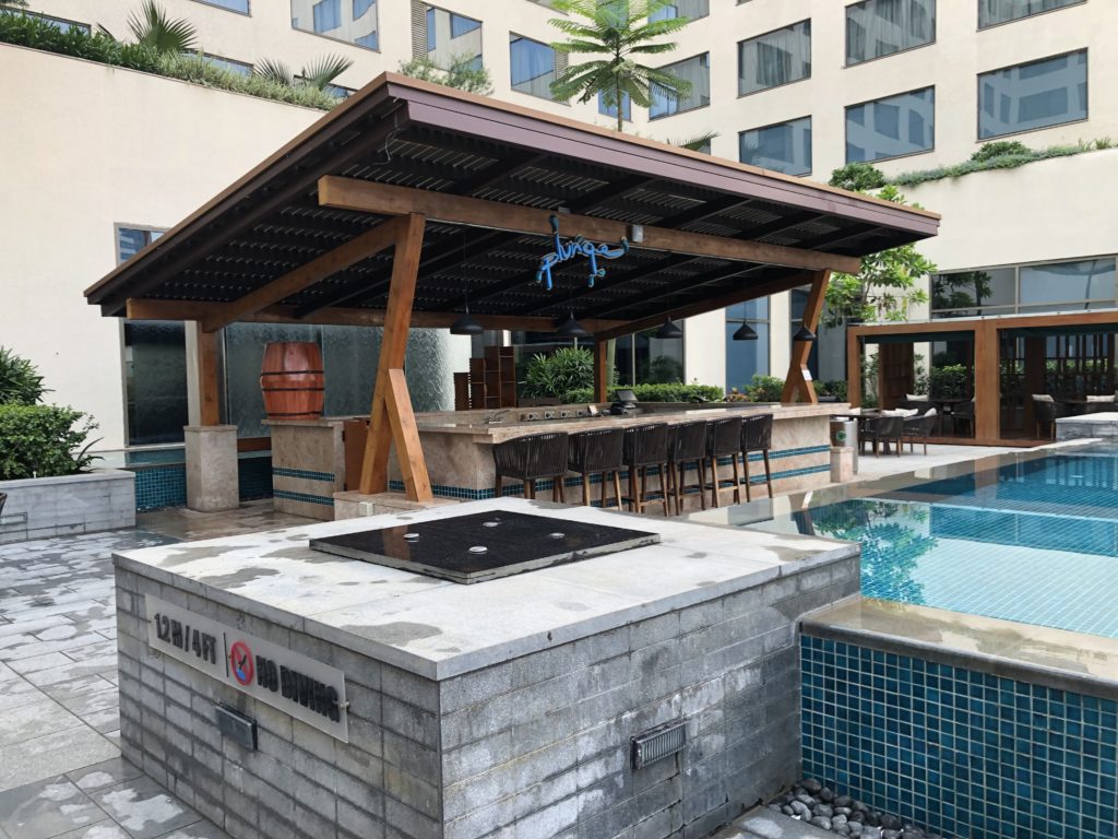 a pool with a bar and a bar stool