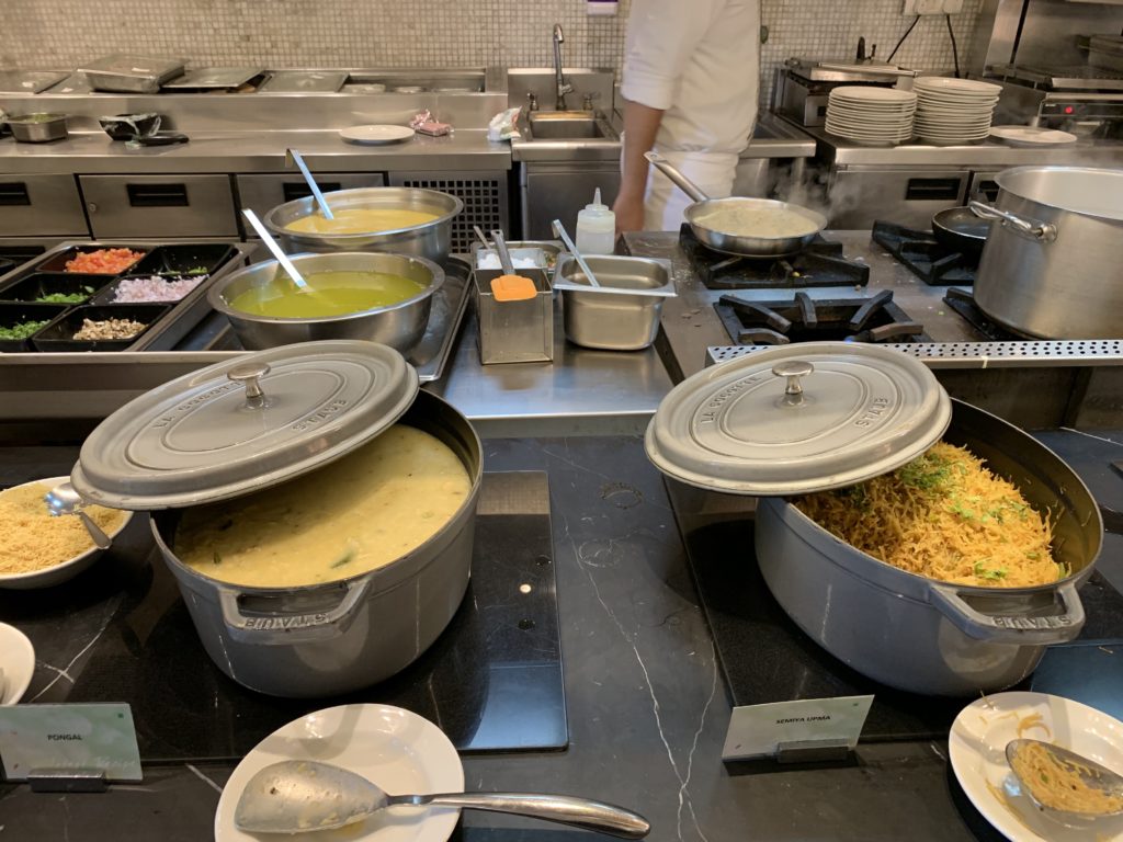a large kitchen with many pots of food