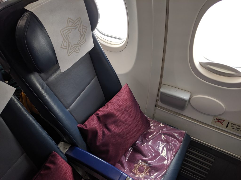 a seat with a pillow and a towel on it