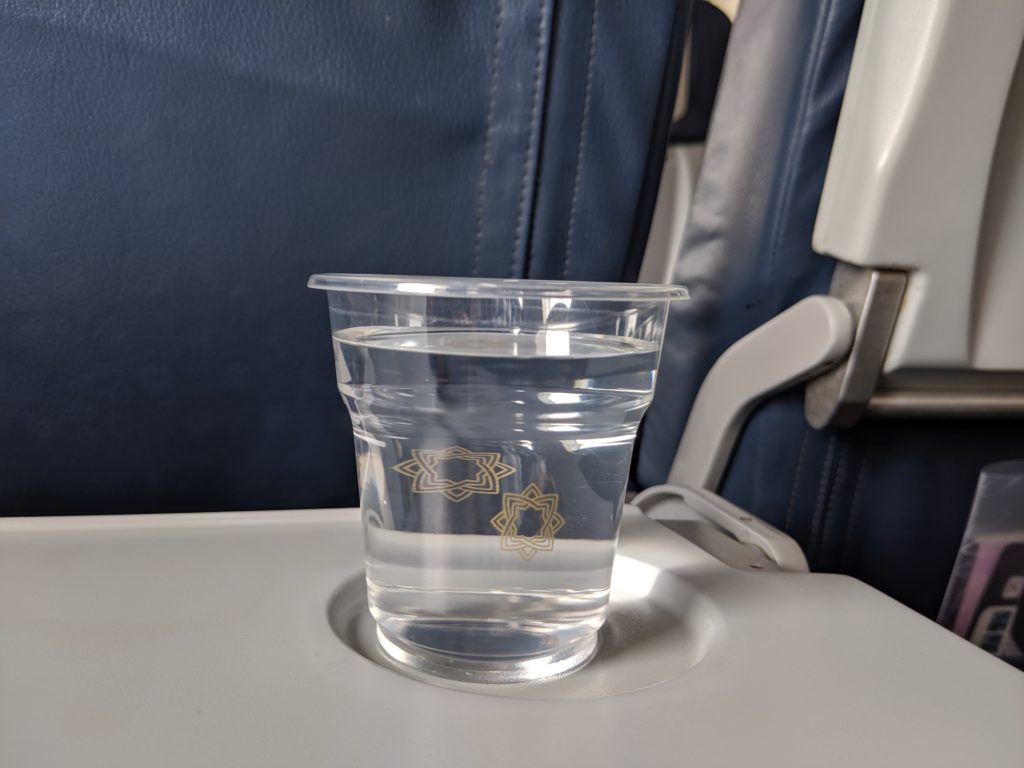 a cup of water on a tray