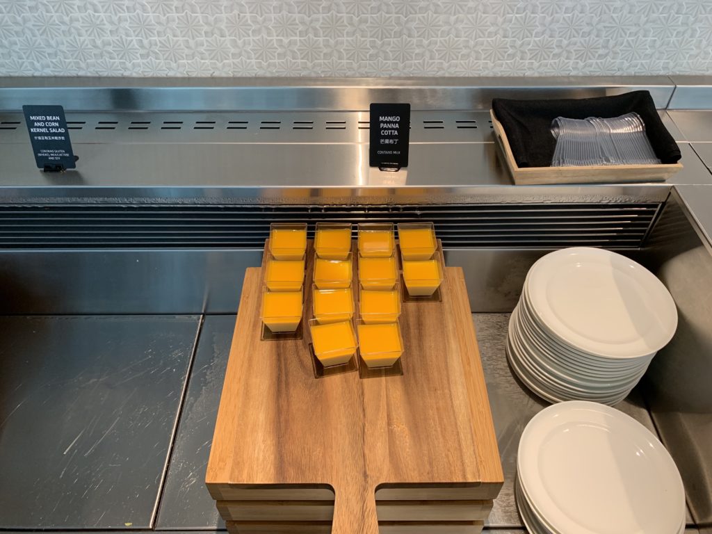 a tray of orange juice on a cutting board