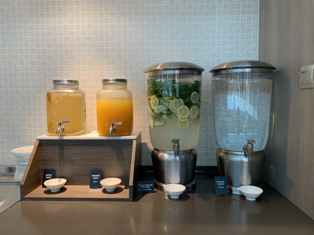 a group of water dispensers with lemons and orange juice