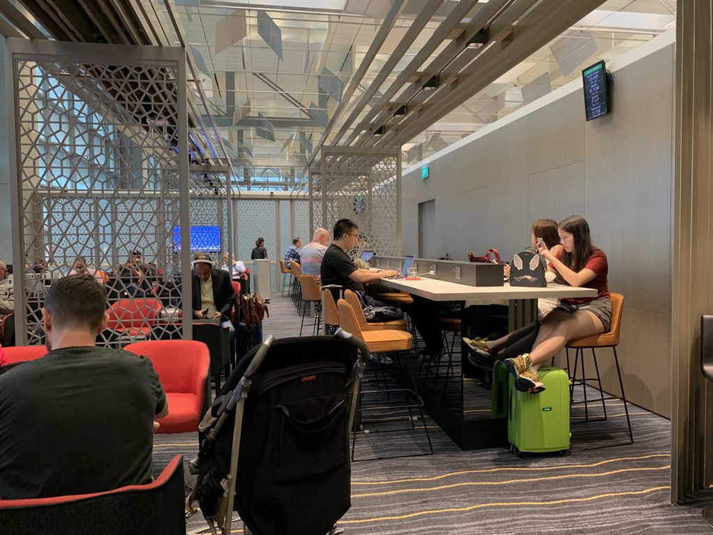 people sitting at a table with luggage
