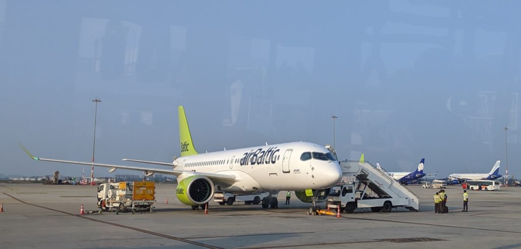 a white and green airplane on a tarmac