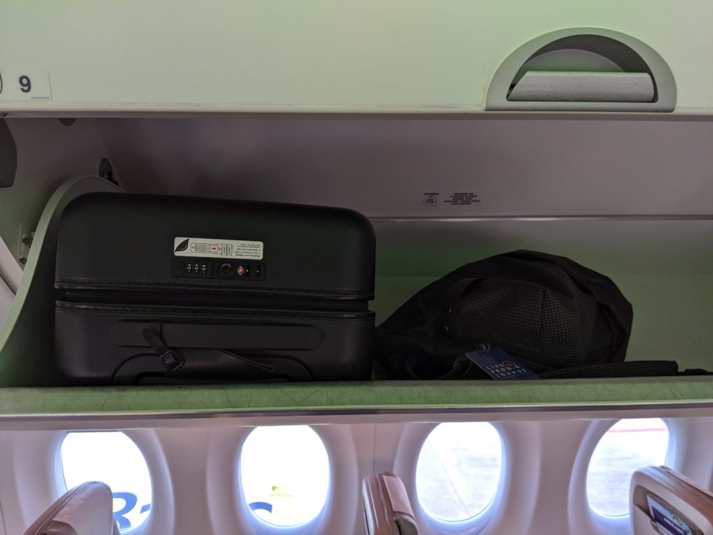 luggage on a shelf with windows