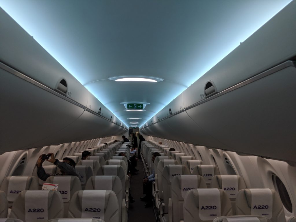 inside an airplane with people sitting on the seats