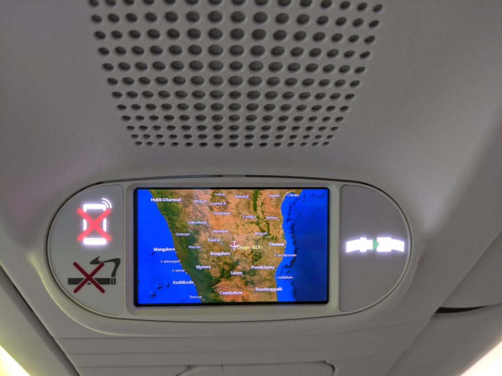 a screen on the ceiling of a plane