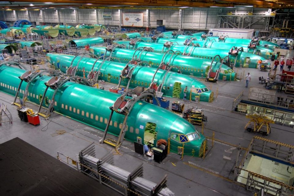 a group of green airplanes in a factory