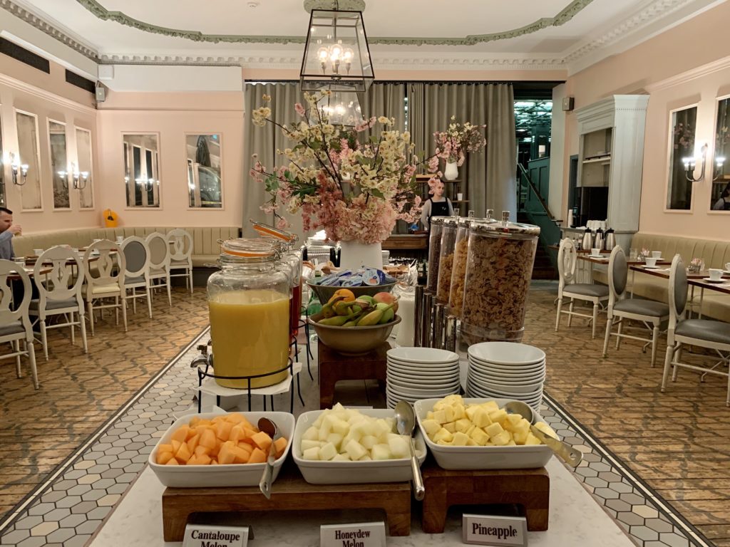 a buffet table with fruit and drinks